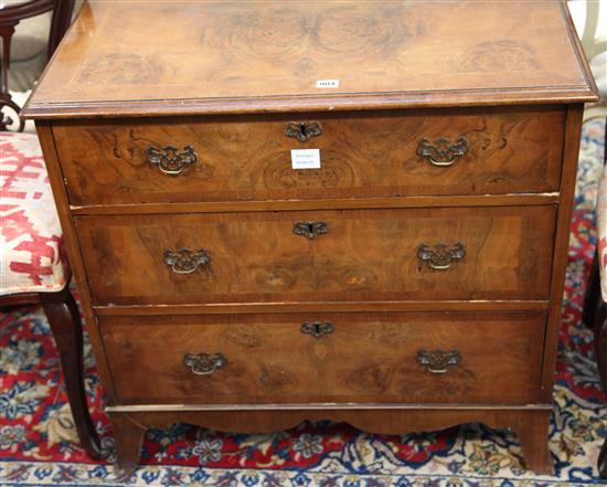 A figured walnut chest, fitted three long drawers, on splayed bracket feet W.80cm